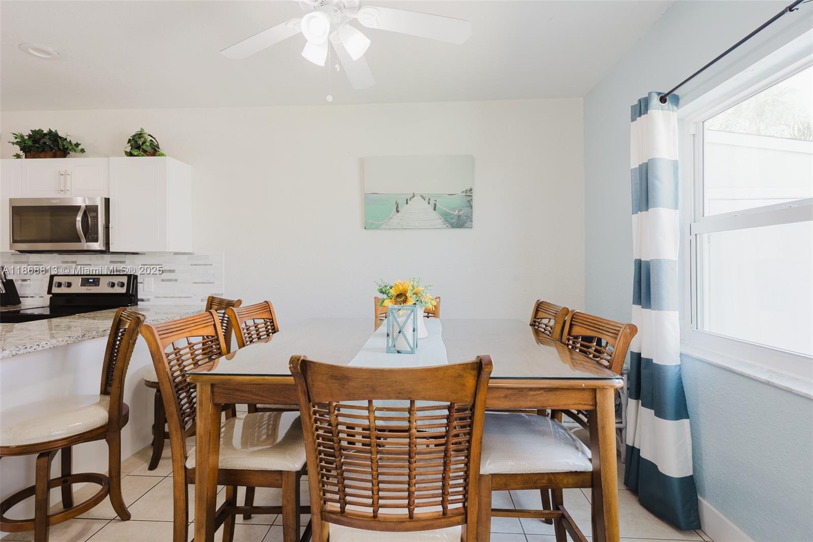 431 5th Street Key Colony Beach, FL 33051 - Photo 13 of 46 a view of a dining room with furniture and a window