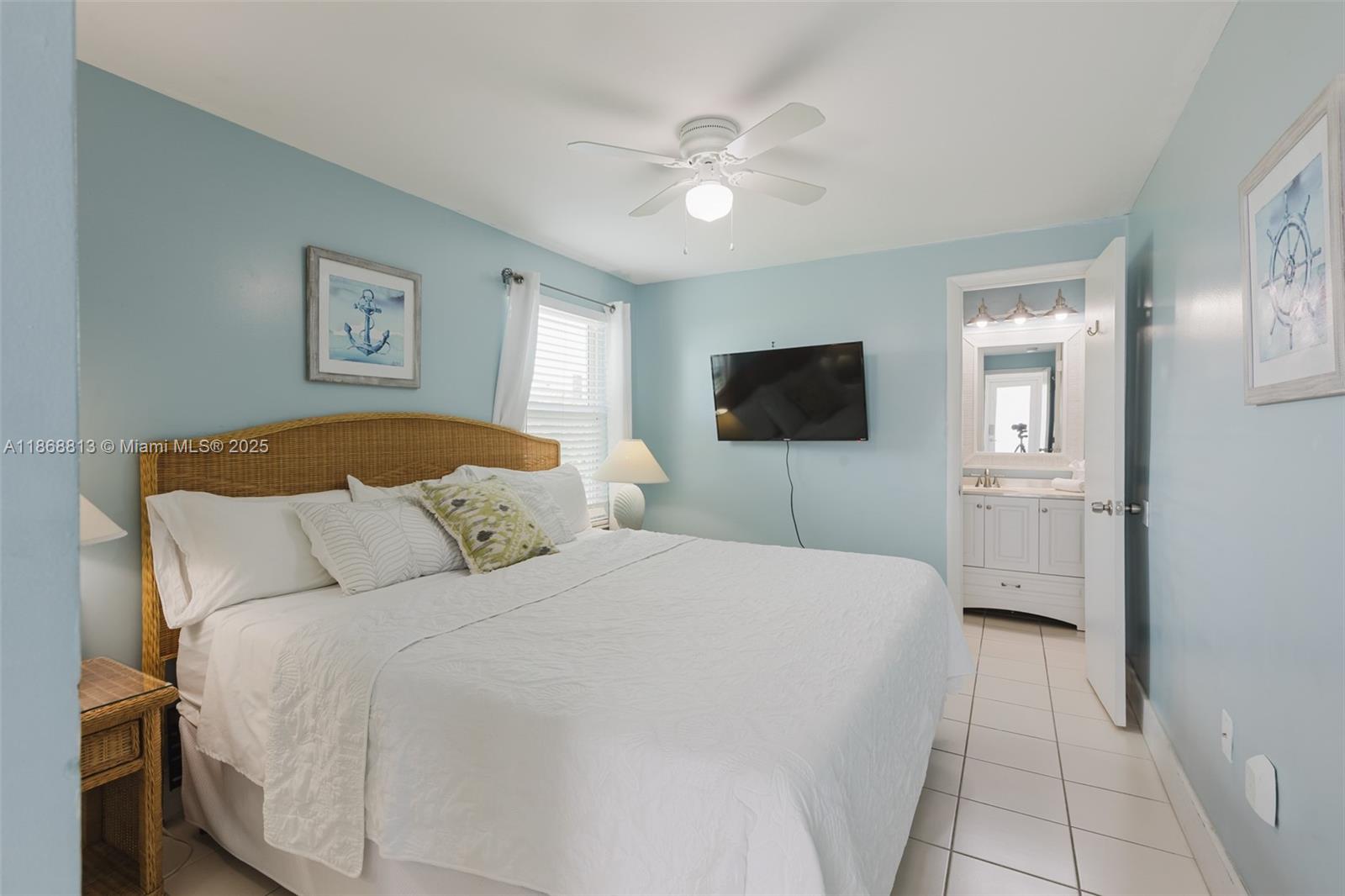 431 5th Street Key Colony Beach, FL 33051 - Photo 15 of 46 a bedroom with a bed and a flat screen tv