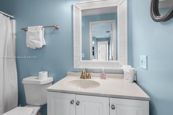 431 5th Street Key Colony Beach, FL 33051 - Photo 17 of 46 a bathroom with a sink a toilet and mirror