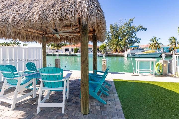 431 5th Street Key Colony Beach, FL 33051 - Photo 34 of 46 a view of a chairs and table in patio with a lake view