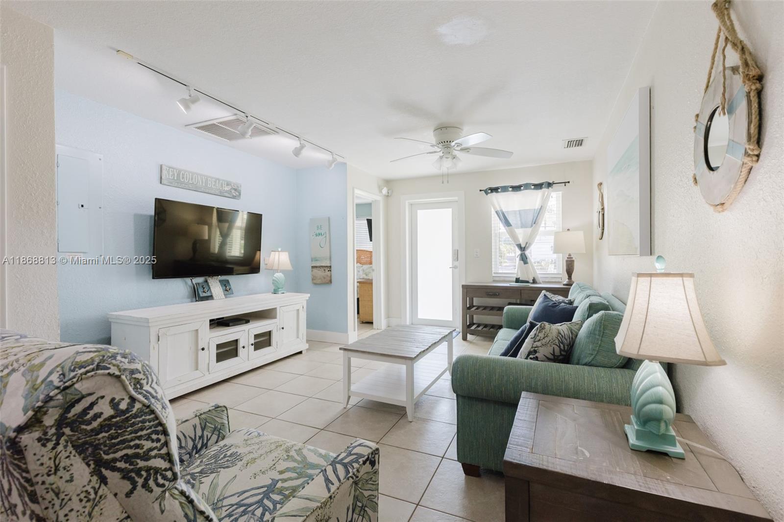 431 5th Street Key Colony Beach, FL 33051 - Photo 4 of 46 a living room with furniture and a flat screen tv