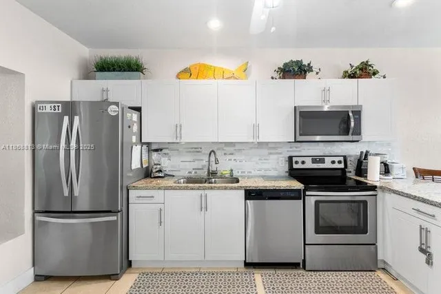 a kitchen with stainless steel appliances a refrigerator stove and microwave