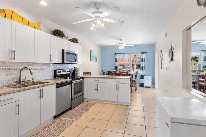 431 5th Street Key Colony Beach, FL 33051 - Photo 10 of 46 a kitchen with a sink cabinets and window
