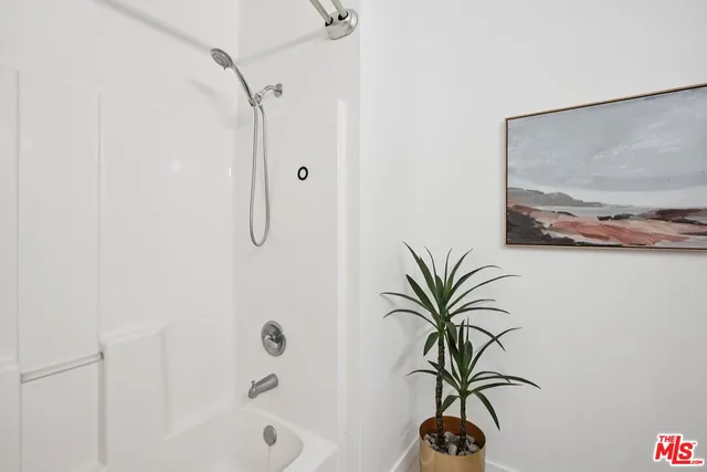 a view of a bathroom with a shower and a sink