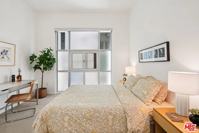a bedroom with a bed and a potted plant