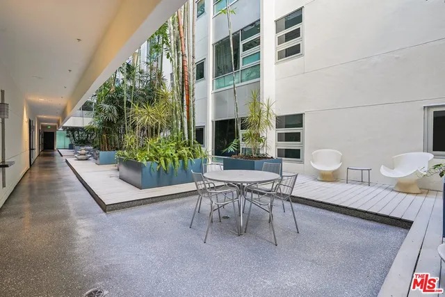 a outdoor space with lots of green space and glass windows