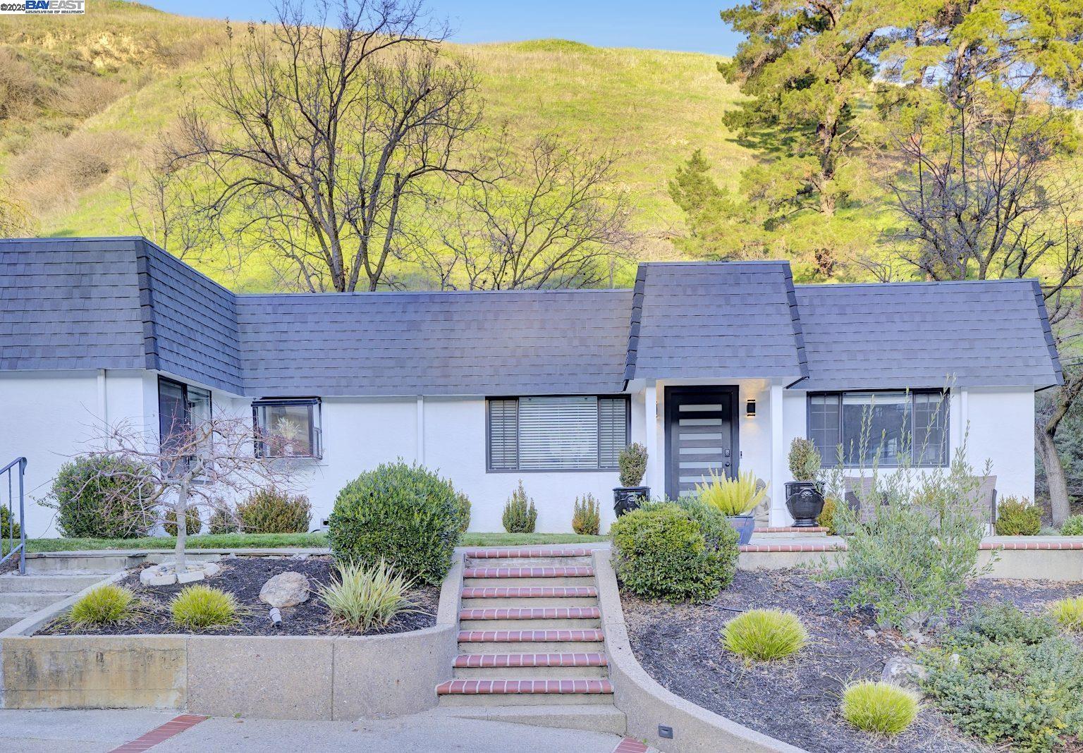 a front view of a house with garden