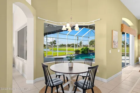 a kitchen with a sink and large windows