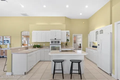 a kitchen with cabinets a sink and wooden floor