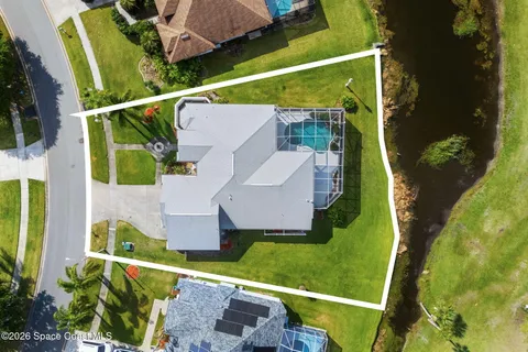 an aerial view of a house with yard swimming pool and outdoor seating