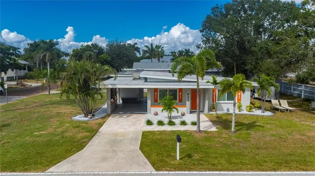 a view of a house with backyard porch and sitting area