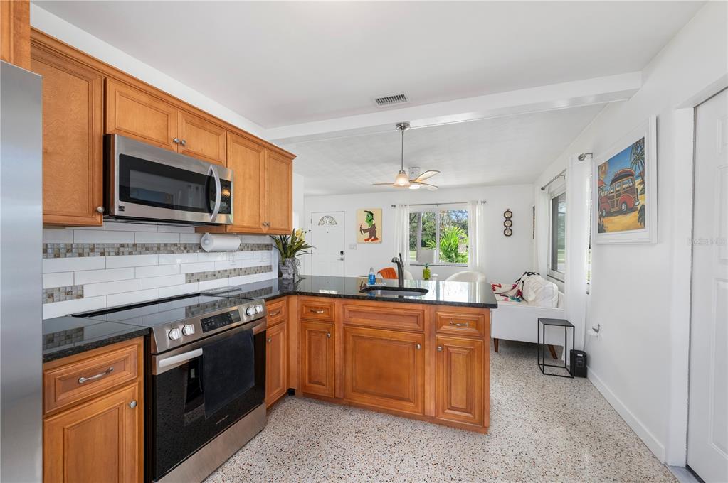 624 West Virginia Avenue Punta Gorda, FL 33950 - Photo 32 of 45 a kitchen with a sink stove and microwave