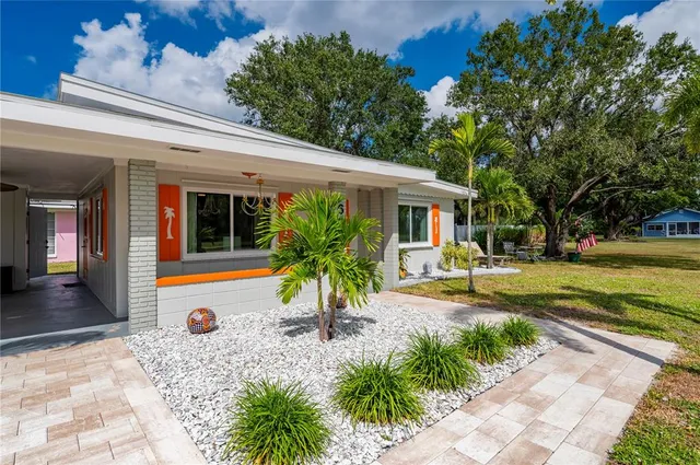 a view of a house with backyard patio and swimming pool