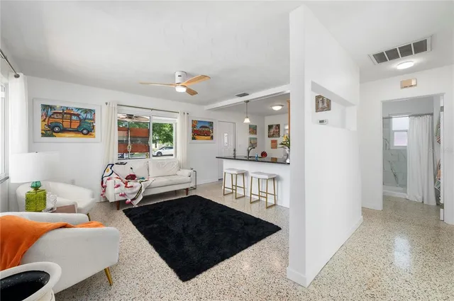 a bathroom with a painting on the wall and a shower