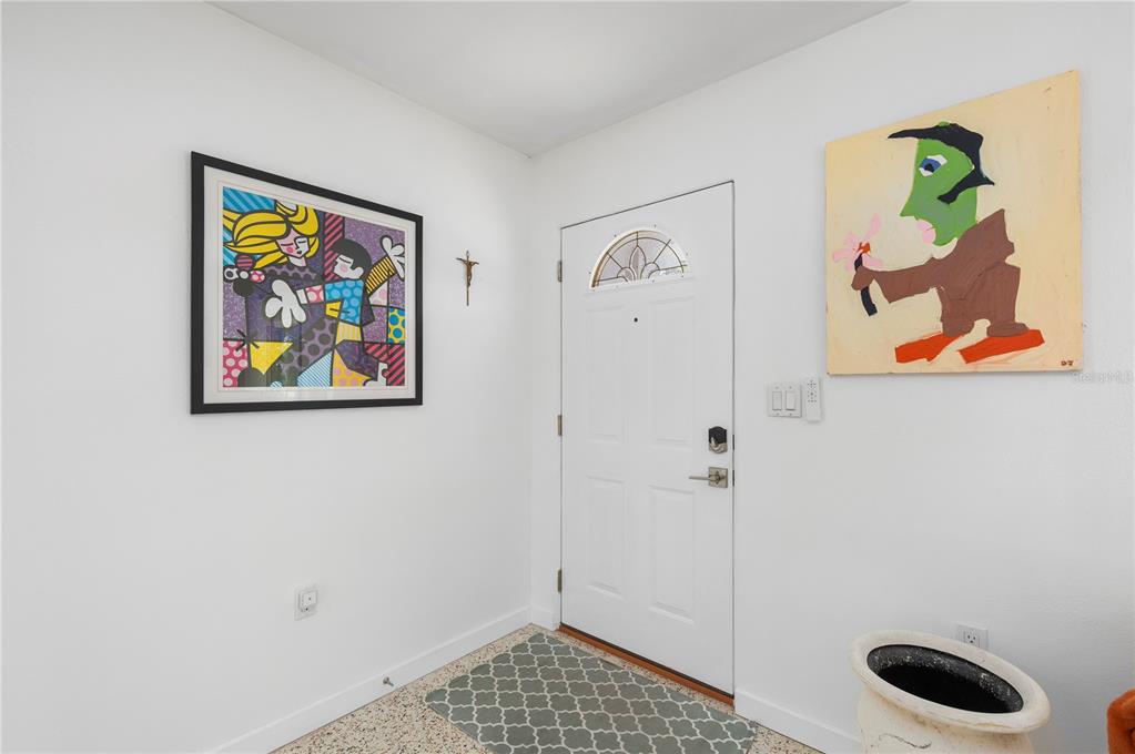 624 West Virginia Avenue Punta Gorda, FL 33950 - Photo 43 of 45 a bathroom with a painting on the wall and a shower