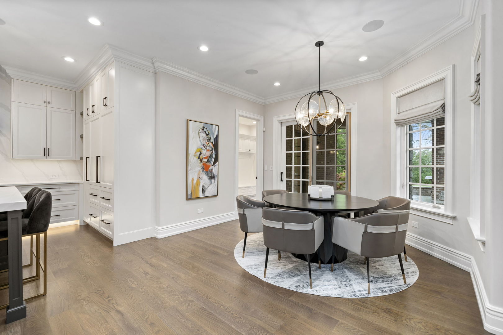 6403 South Garfield Street Burr Ridge, IL 60527 - Photo 23 of 95 a dining room with wooden floor a chandelier a glass table and chairs