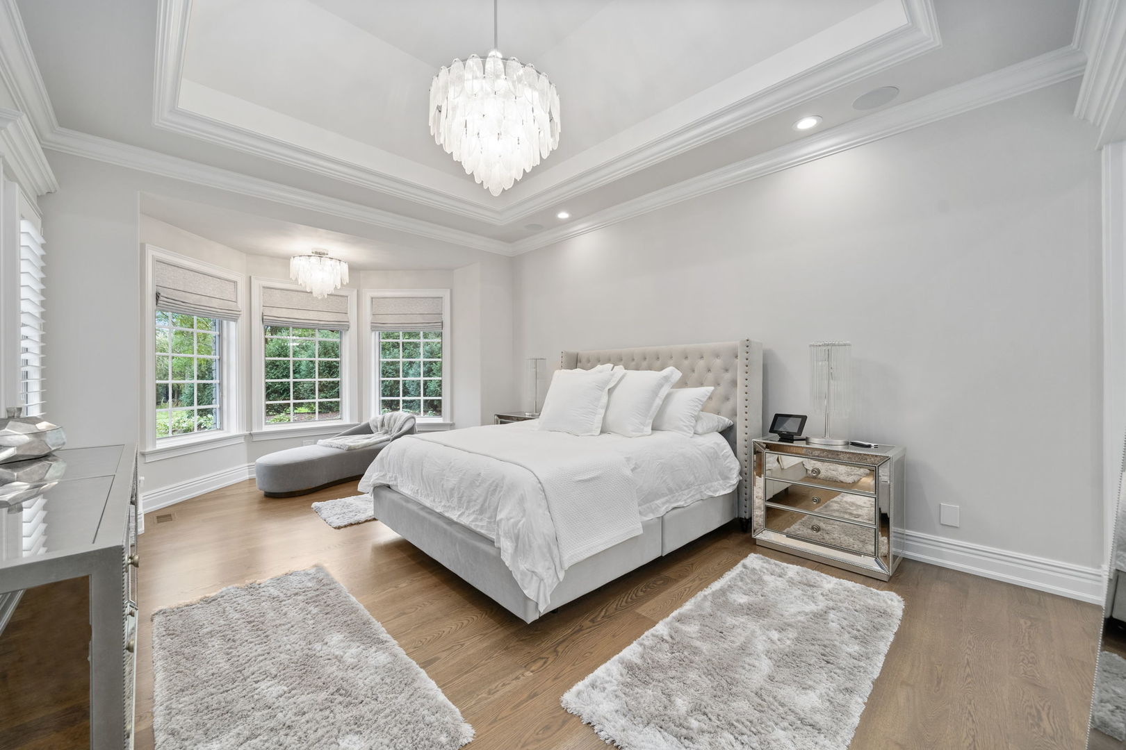 6403 South Garfield Street Burr Ridge, IL 60527 - Photo 25 of 95 a bedroom with a large bed and a chandelier