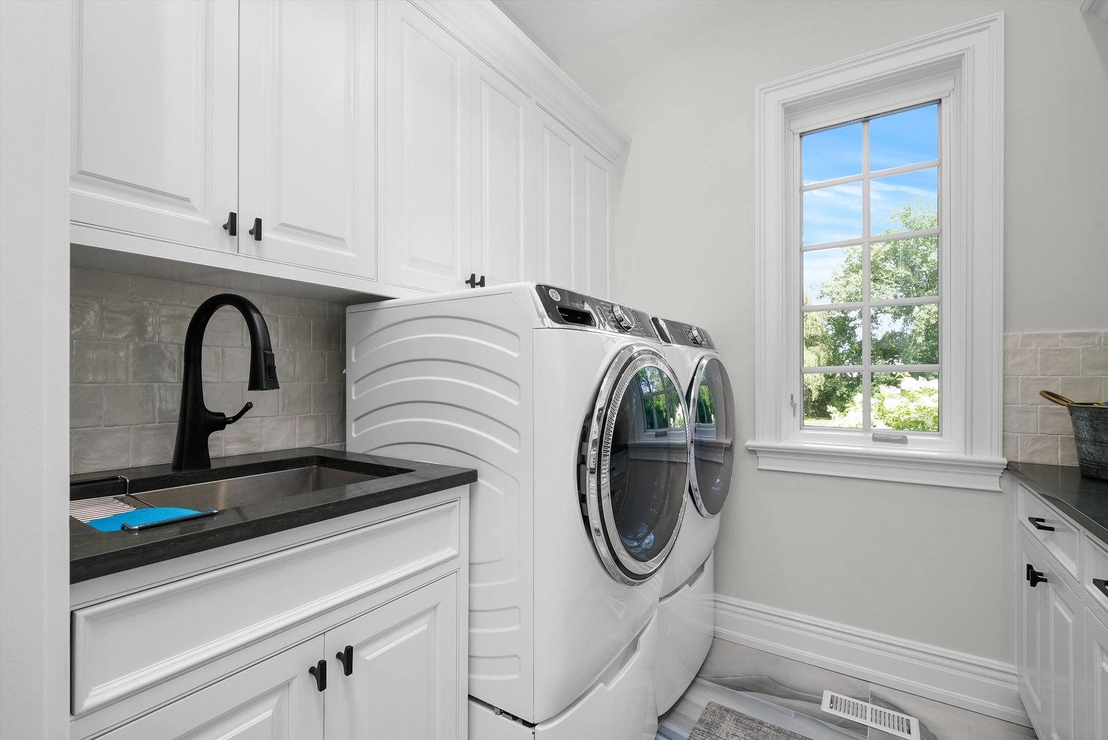 6403 South Garfield Street Burr Ridge, IL 60527 - Photo 39 of 95 a close view of a sink a washer and dryer next to a window