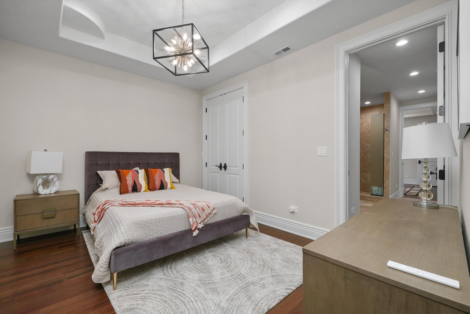 6403 South Garfield Street Burr Ridge, IL 60527 - Photo 52 of 95 a bedroom with a large bed and a chandelier