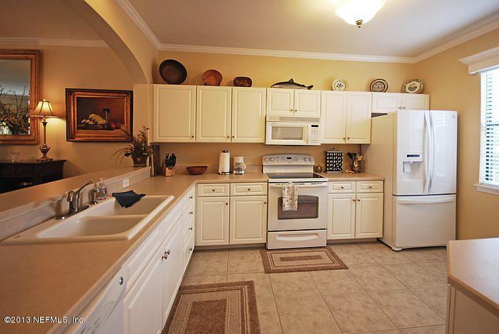 3117 Haley Pointe Road, Unit 3117 St. Augustine, FL 32084 - Photo 3 of 23 a kitchen with white cabinets and white appliances