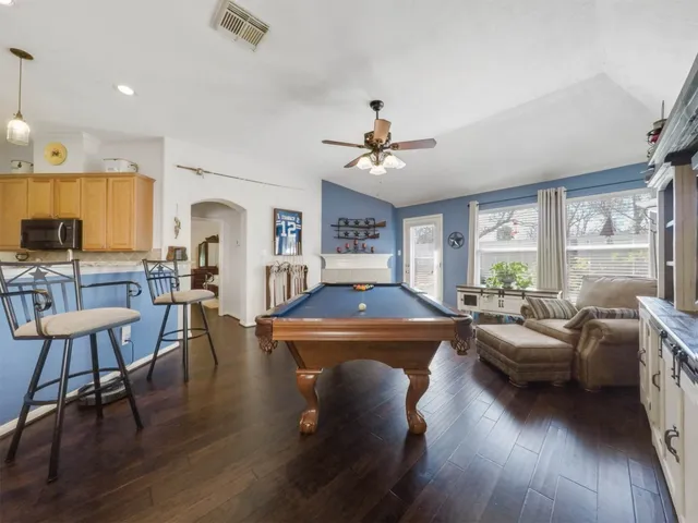a living room with fireplace furniture and a wooden floor