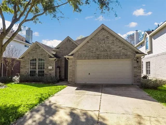 a view of a house with a yard and pathway