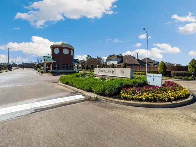 a front view of a house with a garden and plants