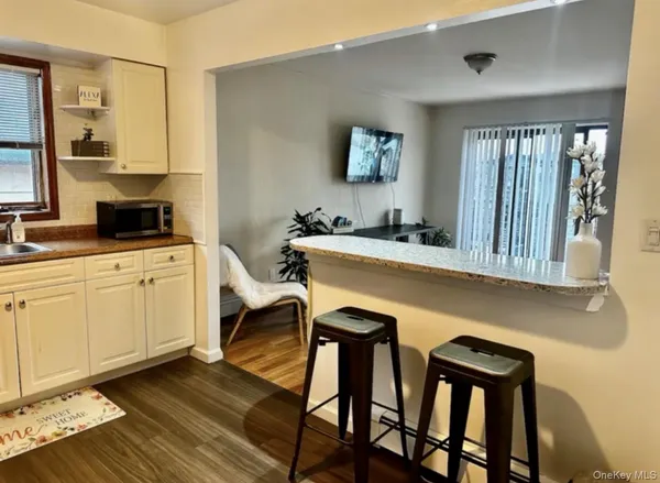 a kitchen with a sink cabinets and wooden floor