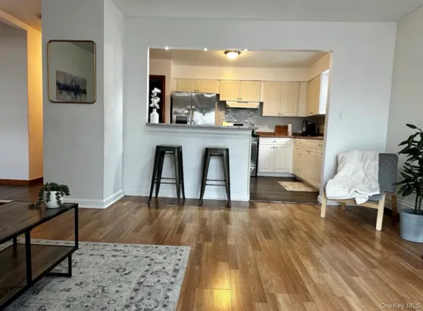 a living room with kitchen island furniture and a wooden floor