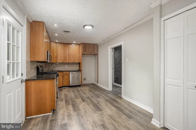 a kitchen with stainless steel appliances granite countertop a refrigerator sink and cabinets