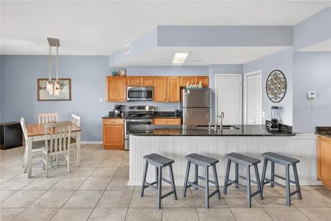 a large kitchen with a table and chairs