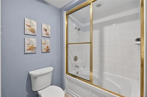 a bathroom with a toilet and a shower