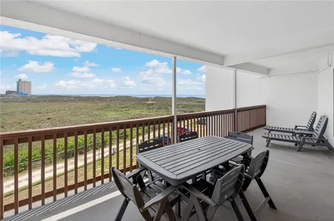 a view of balcony with wooden floor and outdoor seating