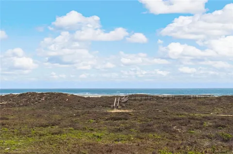 a view of swimming pool with outdoor seating and city view