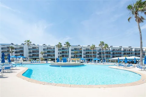 a view of swimming pool with outdoor seating and lake view
