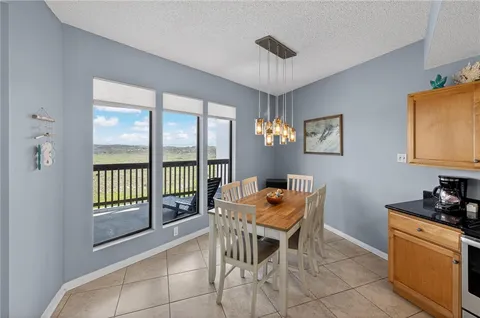 a dining room with furniture a chandelier and window