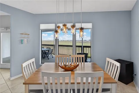 a view of a dining room with furniture a chandelier and wooden floor