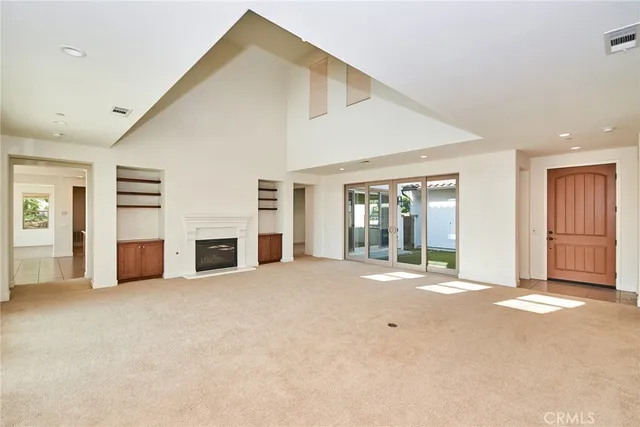 an empty room with closet and a large window