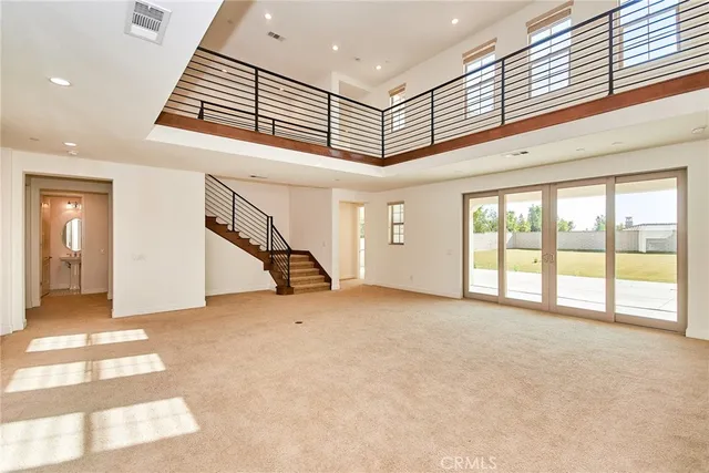 a large kitchen with stainless steel appliances a sink and cabinets