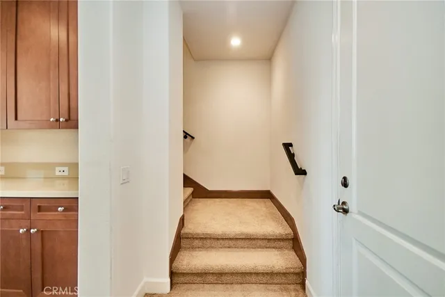 a view of an empty room with a window and fire place