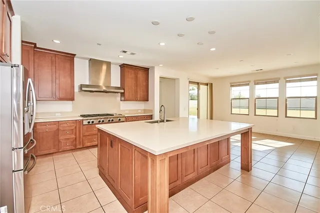 a view of a kitchen with stainless steel appliances granite countertop a large window and a refrigerator