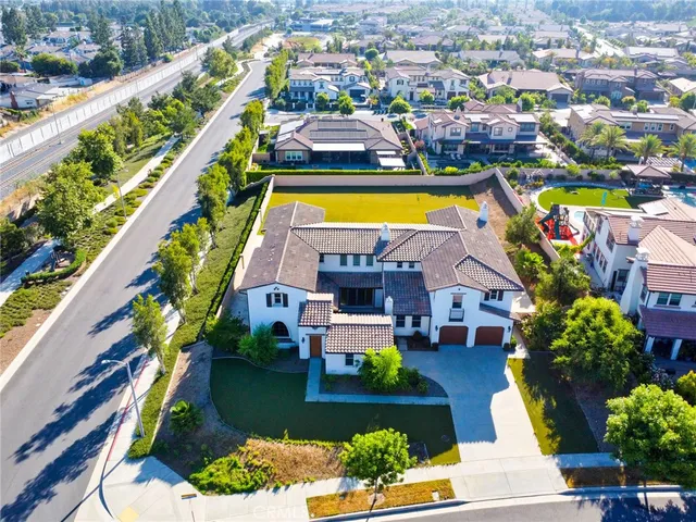an aerial view of a house with a swimming pool yard and outdoor seating
