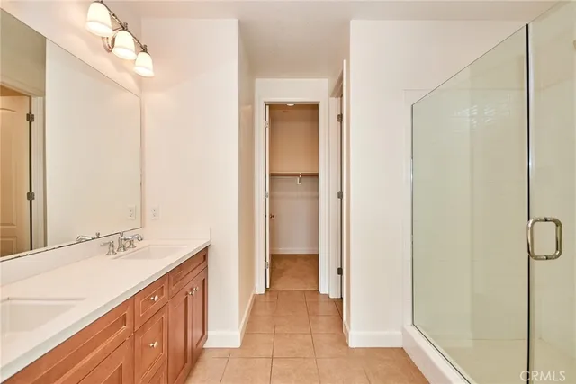 a spacious bathroom with a granite countertop sink mirror and shower