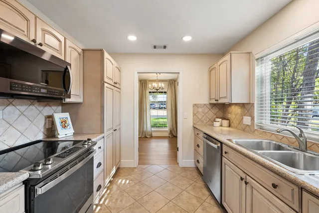 a kitchen that has a sink and a stove