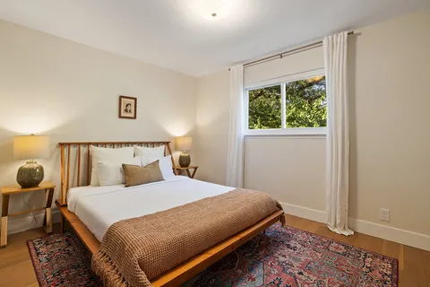 a bedroom with a bed and a window with outer view