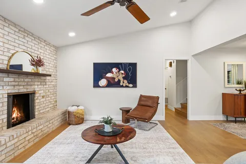 a living room with furniture a rug and a fireplace
