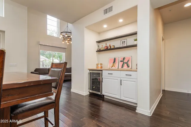 a open kitchen with white cabinets and wooden floor