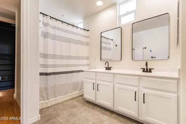 a bathroom with a sink a mirror and a shower