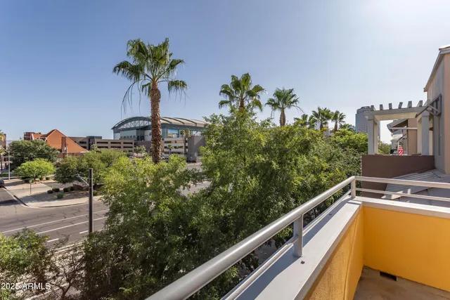 a view of a balcony with potted plants