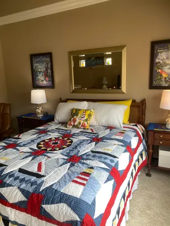 a bedroom with two beds and painting on the wall